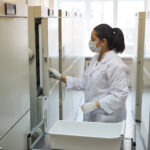 woman standing at laboratory fridge